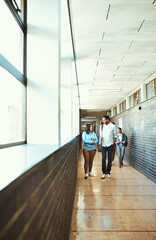 Walking, conversation and students in hallway at university for study tips, advice or guide. Education, people and group of friends talking at college campus for academic scholarship admission exam.