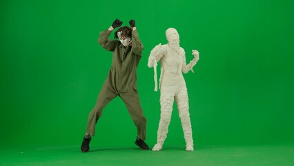 Portrait of person in a mummy bandage on chroma key green screen background. Maniac and mummy...