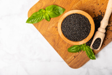 Basil seeds on textured wooden background. Close-up. Superfood. Ocimum basilicum. Organic basil seeds. selasih. Space for text. Copy space.