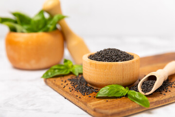 Basil seeds on textured wooden background. Close-up. Superfood. Ocimum basilicum. Organic basil seeds. selasih. Space for text. Copy space.