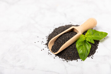 Basil seeds on textured wooden background. Close-up. Superfood. Ocimum basilicum. Organic basil seeds. selasih. Space for text. Copy space.
