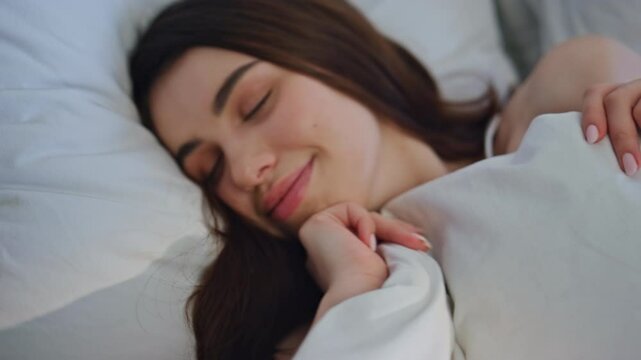 Sleepy woman lying bedding feeling relaxed closeup. Beautiful lady enjoying bed