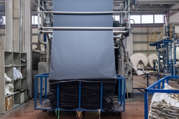 Fabric batching process machine industrial plant line in a textile factory.