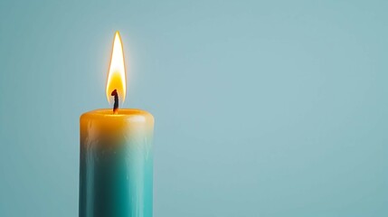 Single Burning Candle on Light Blue Background