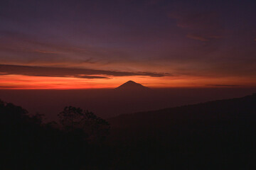 Stunning Sunrise Silhouette of a Distant Volcano