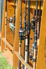Close-up of spinning reels with fishing line on rods.