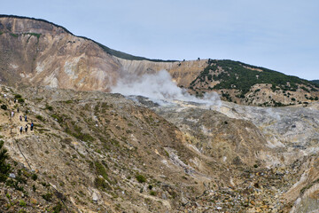 Mountain Hikers Witnessing Volcanic Steam in Action