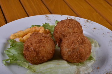 Deep-fried cheese balls on a plate and ketchup. Deep fried Cheese balls. Crispy Cheese. Deep Fried Rice Balls, arancini.