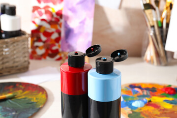 Acrylic paints of different colors on table indoors