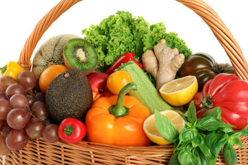 Many different fruits and vegetables in wicker basket isolated on white