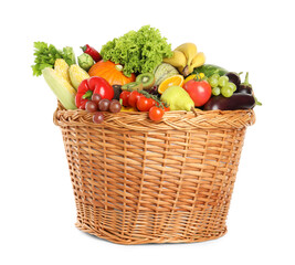 Different fresh fruits and vegetables in wicker basket isolated on white