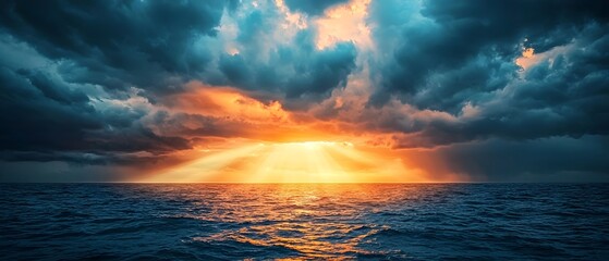 Dramatic sunbeams breaking through dark storm clouds casting a warm glow over the turbulent crashing waves of the open ocean in this epic moody seascape  Copy space for text overlay