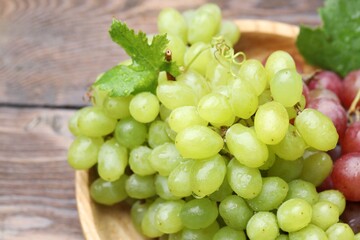 Fresh ripe grapes on wooden table, closeup