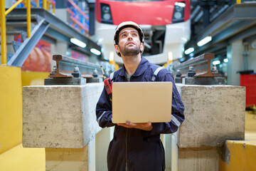 Engineer or worker working on laptop computer at construction train station