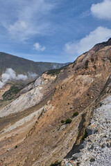 Steaming Crater on a Serene Mountain Slope