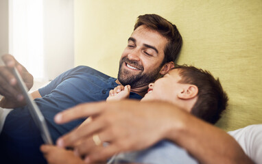 Fototapeta premium Relax, tablet and online with father and son for live streaming, subscription service or technology. Social media, happiness and app with man and child in family home for internet, digital or website