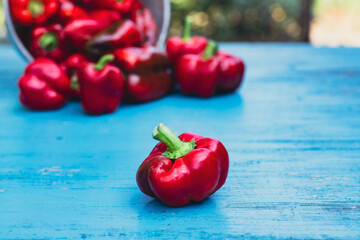 Fresh colorful bell pepper box on wooden table.