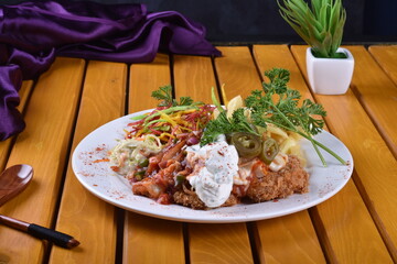 Fried chicken schnitzel cordon bleu with cheese in breadcrumbs is restaurant food. Delicious tender chicken chnitzel with homemade french-fries