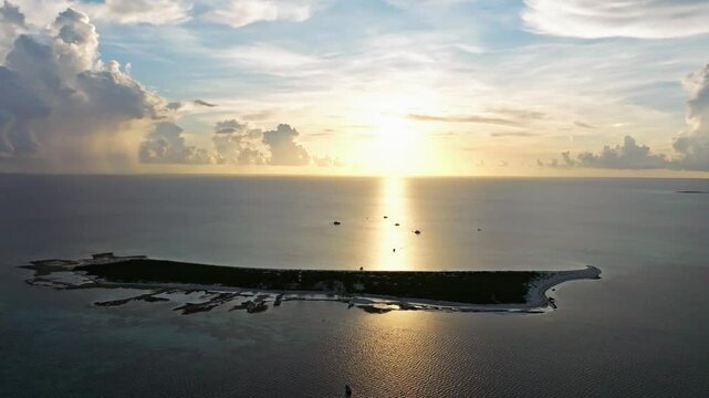Aerial view of tranquil Alacranes Reef at sunset with serene waters and picturesque shoreline, Progreso, Mexico.