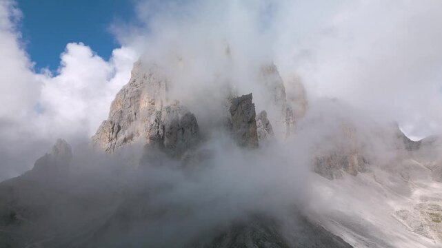 Aerial drone view of The Dolomites Mountain peaks with Moody Weather in the Province of Trento, South Tirol, Italy