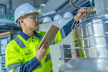 Asian engineer working at Operating hall,Thailand people wear helmet  work,He worked with diligence...