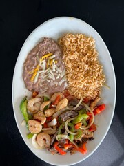 Mexican Chicken Fajitas with Rice and Beans on Table