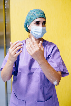 Female surgeon preparing in hospital with safety protocols