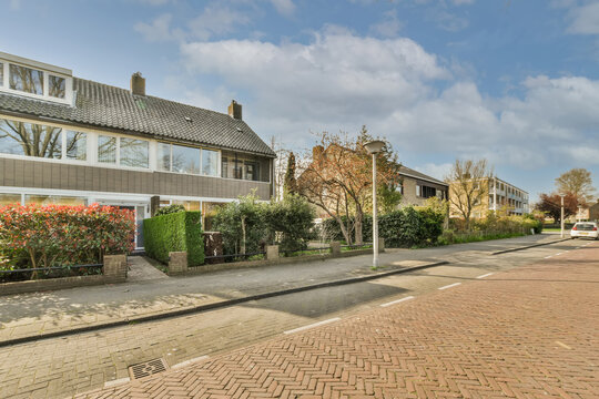 Tranquil suburban street with row houses and greenery