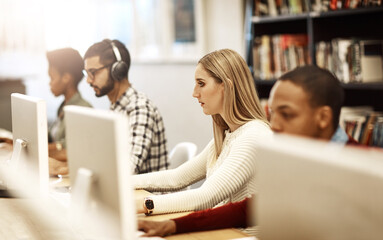 Girl, computer and students learning at library for education, knowledge or test preparation in college. University research, woman and internet for studying, project notes and online exam report