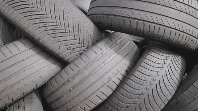 Stack of used car tires waiting to be recycled