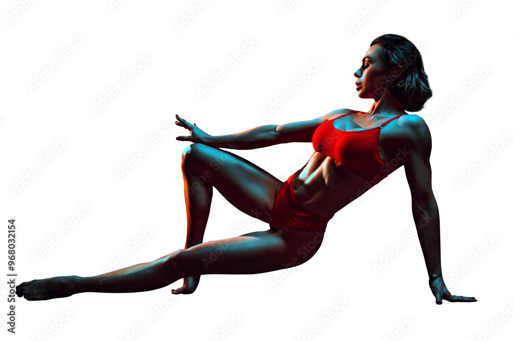 Wall mural Young sports woman in red lingerie posing on dark background