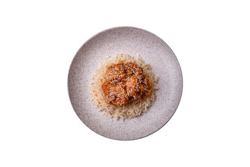 Asian food boiled rice with meat with sweet and sour sauce, spices and herbs