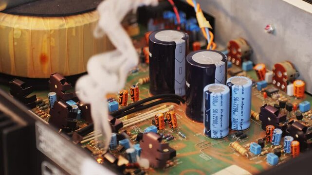 Soldering iron repair of Radio parts of the old amplifier, vintage transistors and chips, hi-fi vintage audio player close up.