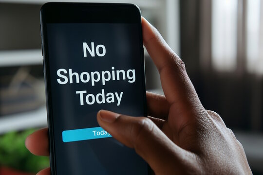 African american female hand holding smartphone with "No Shopping Today" message on the screen. Concept of minimalism, conscious consumerism, Buy Nothing Day