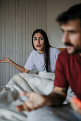 Unhappy couple having crisis and difficulties in relationship because of the smartphone