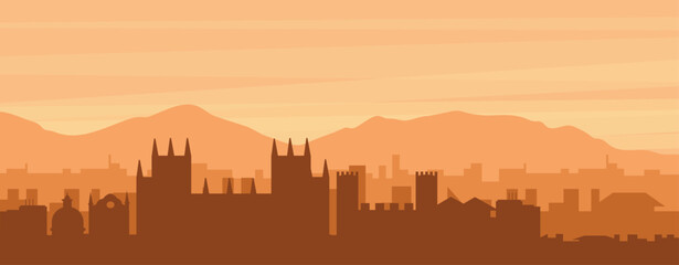 Fototapeta premium Brown panoramic poster of the city skyline with misty background buildings, sunrise, clouds and mountains of CANTERBURY, UNITED KINGDOM