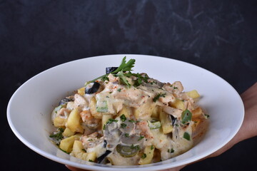 A top-down view of a bowl of chicken shawarma fries. Loaded fries on the table