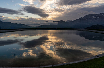 colourful sunrise at the reservoir Leiterli, in Lenk in the Swiss alps