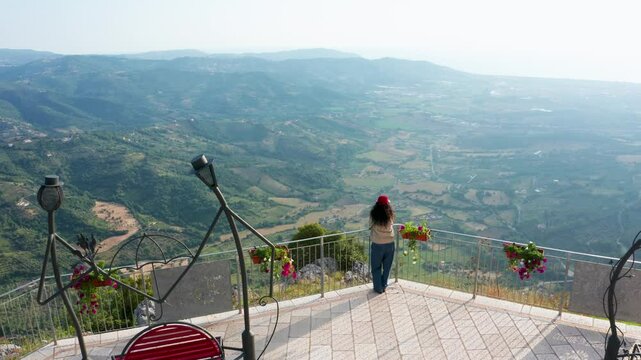 Aerial view of scenic Terrazza degli innamorati overlooking a peaceful valley with flowers and mountains, Trentinara, Italy.