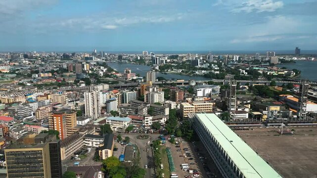 Aerial view of vibrant skyline with modern buildings and a river, Lagos Island, Nigeria.
