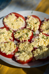 Tomatoes with cheese. Tomatoes sliced with cheese and sprinkled with dill on top