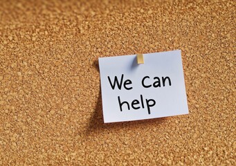 Cork panel with a piece of paper that says We can help. Collaboration concept
