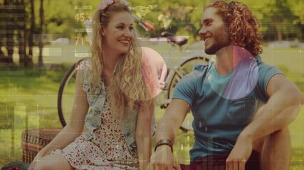 Animation of financial data processing over caucasian couple having picnic in park - Powered by Adobe