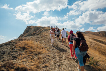 People hiking climbing to the top of the mountain on a journey