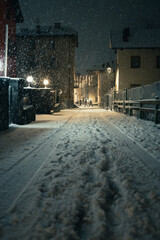 Moody evening night in the city during a snowfall on New Years Eve, Aprica, Northern Italy