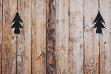wooden window shutters with christmas tree cut out, rustic vintage design. old wooden shutters with holes cut in the shape of spruce