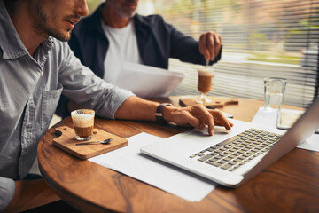 Laptop, hands or business people in cafe for meeting, teamwork or financial investment paperwork. Coffee, beverage or budget analyst with economist for research feedback, planning or startup project