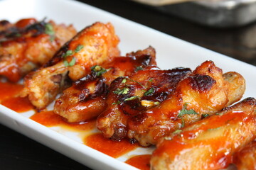 Spicy Fresh Grilled Chicken Wings on White Plate Restaurant Top View