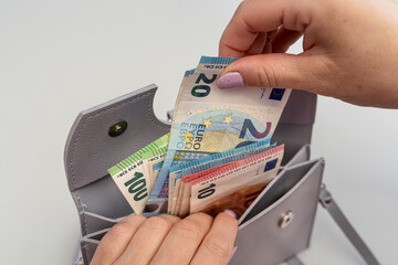 close up  woman taking euro money out of the wallet for shopping. Saving conept