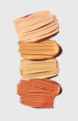 Cosmetic concealer or foundation smudge assortment set palette on gray vertical background